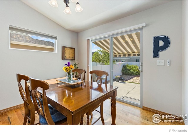 1613 Alpine Ave, Berthoud, CO 80513 - dining space featuring a chandelier, light wood-style flooring, and lofted ceiling