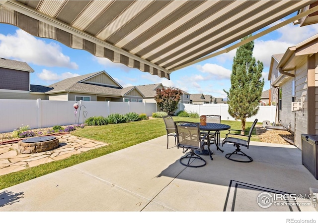 1613 Alpine Ave, Berthoud, CO 80513 - fenced backyard with a fire pit, outdoor dining space, a patio area, and a residential view