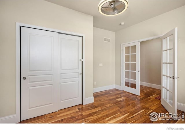 5127 Exploration Ln, Fort Collins, CO 80528 - unfurnished bedroom featuring french doors, wood finished floors, and a closet