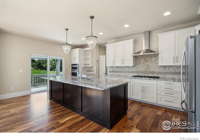 5127 Exploration Ln, Fort Collins, CO 80528 - kitchen with wall chimney range hood, appliances with stainless steel finishes, white cabinetry, tasteful backsplash, and a chandelier