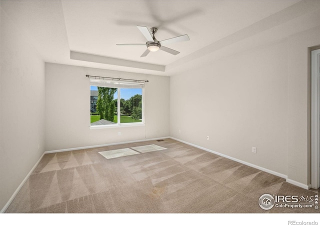 5127 Exploration Ln, Fort Collins, CO 80528 - unfurnished room featuring a raised ceiling, ceiling fan, and carpet