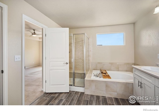 5127 Exploration Ln, Fort Collins, CO 80528 - full bath with vanity, a shower stall, a garden tub, a ceiling fan, and wood finished floors