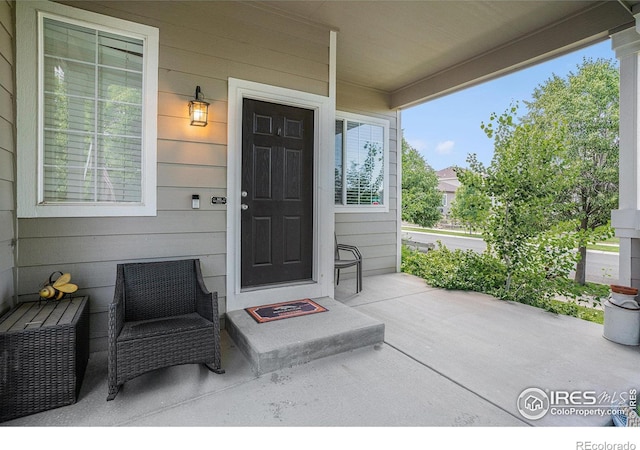 1201 102nd Ave, Greeley, CO 80634 - doorway to property featuring a porch