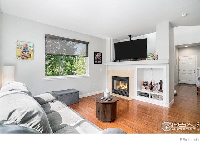 1201 102nd Ave, Greeley, CO 80634 - living room with wood finished floors and a tiled fireplace