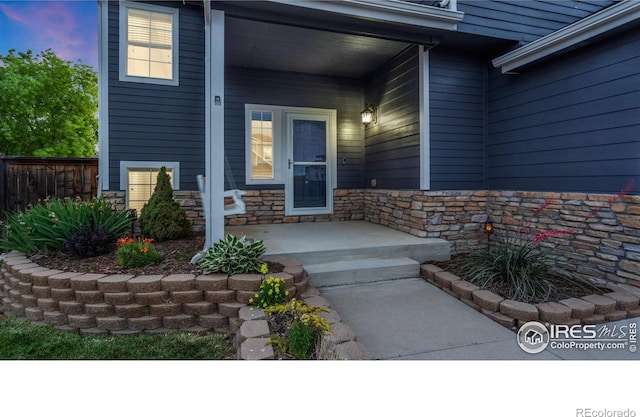 1937 Mahogany Way, Severance, CO 80550 - view of exterior entry featuring a porch and stone siding