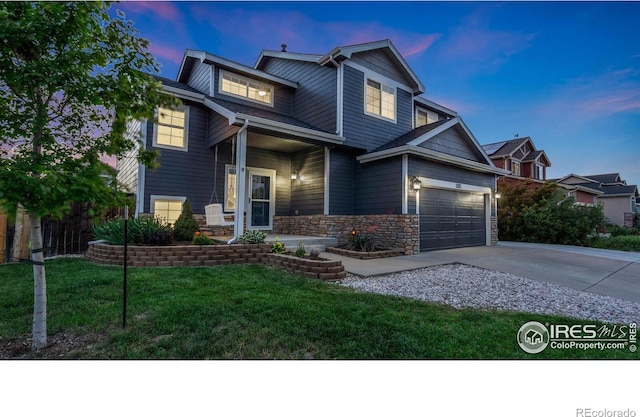 1937 Mahogany Way, Severance, CO 80550 - view of front facade featuring a porch, concrete driveway, stone siding, and a front lawn