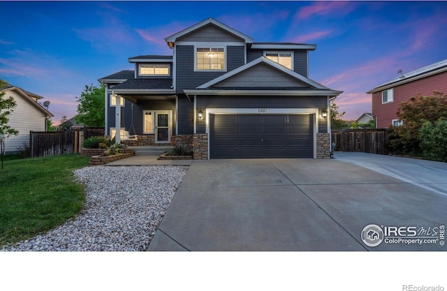1937 Mahogany Way, Severance, CO 80550 - view of front of home featuring driveway, stone siding, and a garage