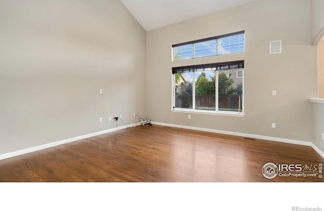 1937 Mahogany Way, Severance, CO 80550 - spare room with wood finished floors and high vaulted ceiling