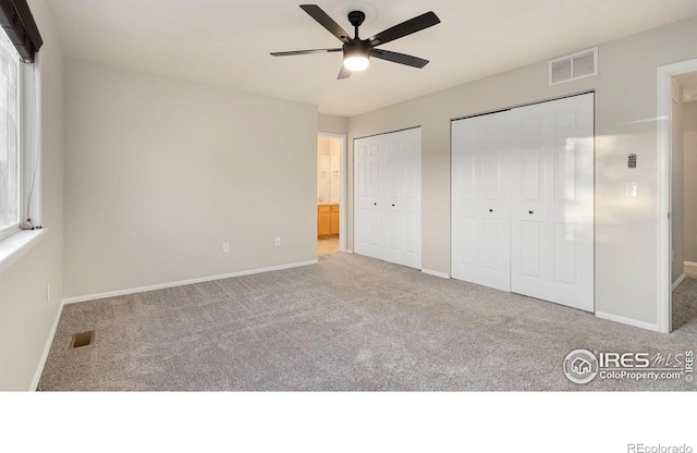 1937 Mahogany Way, Severance, CO 80550 - unfurnished bedroom featuring carpet, two closets, and ceiling fan