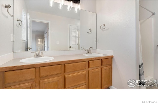1937 Mahogany Way, Severance, CO 80550 - bathroom featuring double vanity and a shower with shower curtain