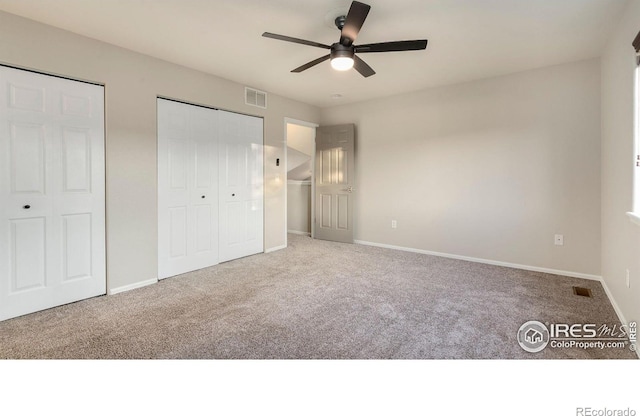 1937 Mahogany Way, Severance, CO 80550 - unfurnished bedroom featuring carpet, multiple closets, and ceiling fan