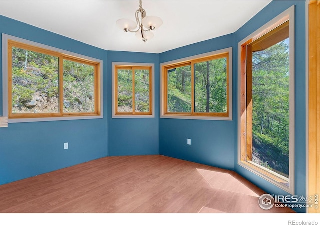 3727 Gamble Gulch Rd, Black Hawk, CO 80422 - empty room with a chandelier, healthy amount of natural light, and wood finished floors
