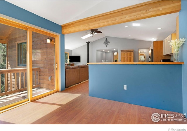 3727 Gamble Gulch Rd, Black Hawk, CO 80422 - kitchen with vaulted ceiling, wood finished floors, ceiling fan, freestanding refrigerator, and a peninsula