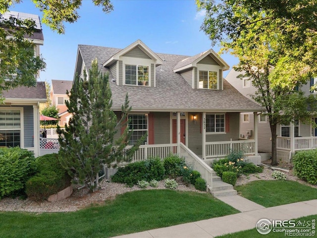 3632 Cassiopeia Ln, Fort Collins, CO 80528 - view of front of house featuring roof with shingles, a porch, and a front lawn