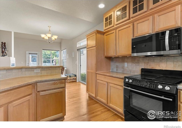 3632 Cassiopeia Ln, Fort Collins, CO 80528 - kitchen with electric range, stainless steel microwave, a chandelier, light wood-type flooring, and light countertops