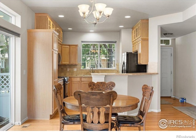 3632 Cassiopeia Ln, Fort Collins, CO 80528 - kitchen featuring black appliances, light brown cabinetry, light wood finished floors, backsplash, and recessed lighting
