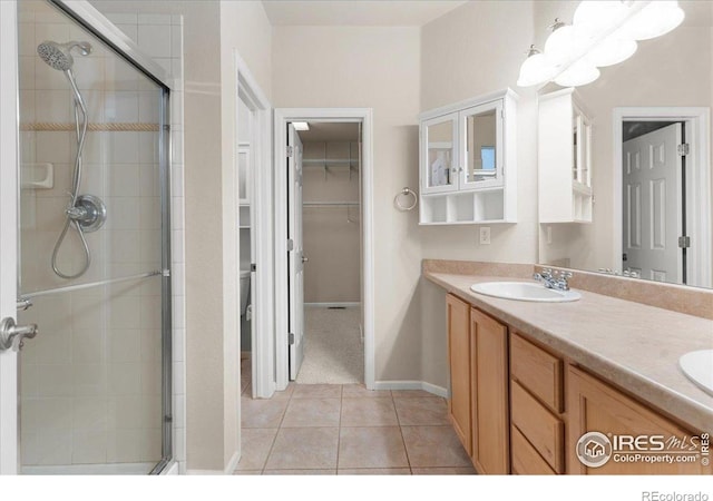 3632 Cassiopeia Ln, Fort Collins, CO 80528 - bathroom featuring a stall shower, a walk in closet, tile patterned floors, and double vanity