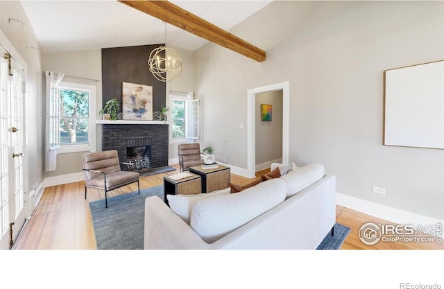 5326 Lowell Blvd, Denver, CO 80221 - living area featuring plenty of natural light, beamed ceiling, a fireplace, wood finished floors, and high vaulted ceiling