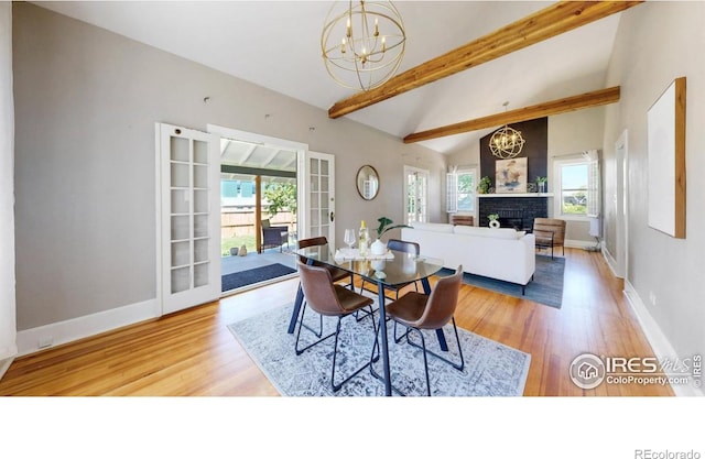5326 Lowell Blvd, Denver, CO 80221 - dining room featuring a chandelier, a brick fireplace, and wood finished floors
