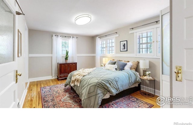 5326 Lowell Blvd, Denver, CO 80221 - bedroom with multiple windows and wood finished floors