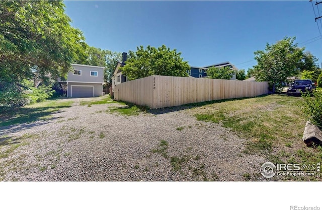 5326 Lowell Blvd, Denver, CO 80221 - view of yard featuring a garage and gravel driveway