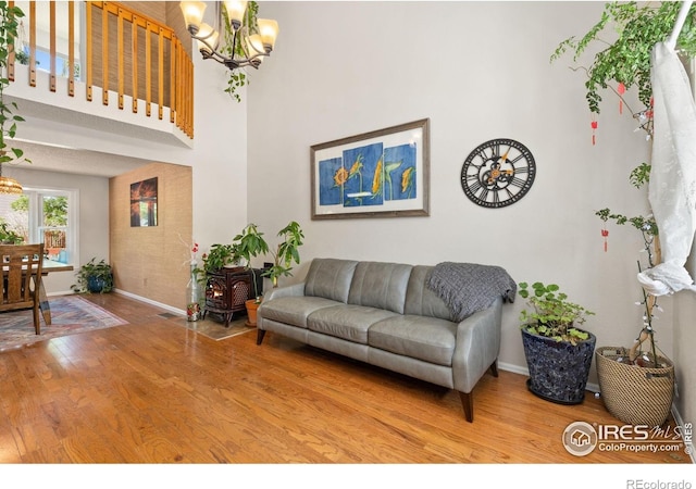 1026 Red Oak Dr, Longmont, CO 80504 - living room with a chandelier, wood finished floors, and a high ceiling