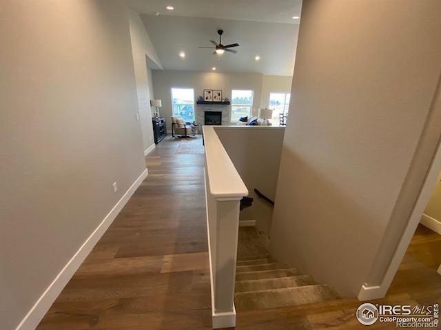 7156 Feather Reed Dr, Wellington, CO 80549 - staircase with ceiling fan, a fireplace, recessed lighting, and wood finished floors