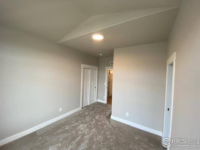 7156 Feather Reed Dr, Wellington, CO 80549 - unfurnished bedroom with lofted ceiling, carpet flooring, and a closet