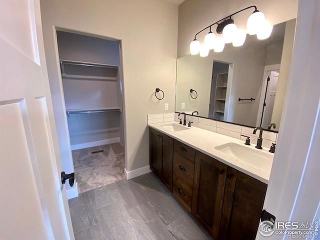 7156 Feather Reed Dr, Wellington, CO 80549 - bathroom with double vanity and a spacious closet