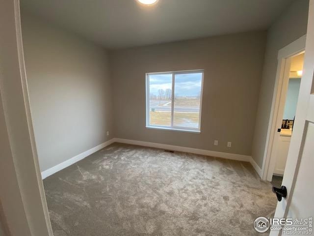 7156 Feather Reed Dr, Wellington, CO 80549 - carpeted empty room featuring baseboards