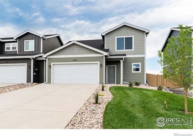 3178 Buffalo Grass Ln, Wellington, CO 80549 - view of front of home featuring concrete driveway, an attached garage, and board and batten siding