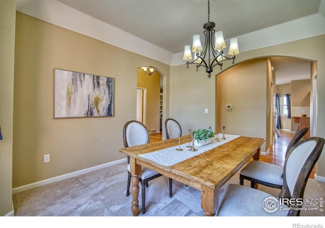 2408 Eagleview Cir, Longmont, CO 80504 - carpeted dining room with arched walkways and a chandelier
