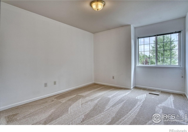2408 Eagleview Cir, Longmont, CO 80504 - spare room featuring carpet flooring and baseboards