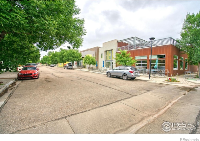 2408 Eagleview Cir, Longmont, CO 80504 - view of concrete road featuring sidewalks, curbs, and street lights