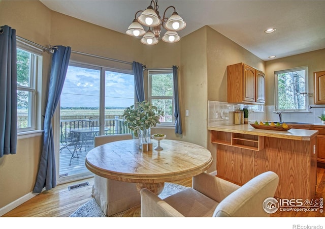 2408 Eagleview Cir, Longmont, CO 80504 - dining room featuring light wood-style floors, recessed lighting, and a chandelier