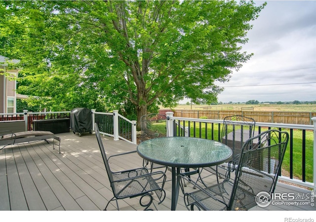 2408 Eagleview Cir, Longmont, CO 80504 - wooden terrace featuring grilling area, a fenced backyard, and outdoor dining area