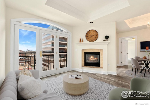 1827 N Grant St Unit 604, Denver, CO 80203 - living area with a raised ceiling, crown molding, wood finished floors, and a glass covered fireplace