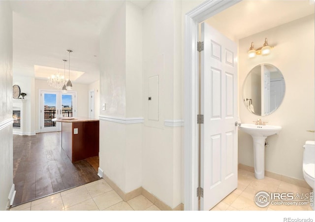1827 N Grant St Unit 604, Denver, CO 80203 - bathroom with tile patterned floors, a chandelier, electric panel, and a glass covered fireplace