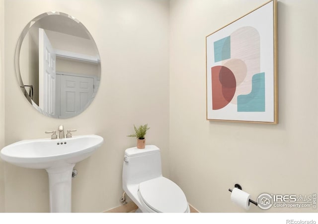 1827 N Grant St Unit 604, Denver, CO 80203 - half bath featuring toilet and a sink
