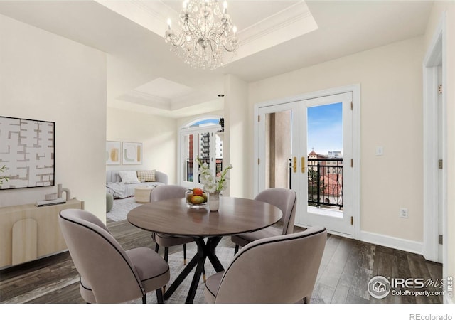 1827 N Grant St Unit 604, Denver, CO 80203 - dining space with a tray ceiling, wood finished floors, a chandelier, french doors, and ornamental molding