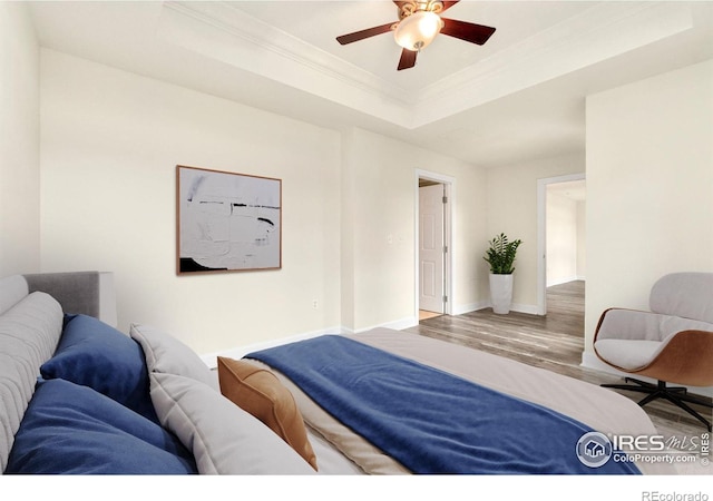 1827 N Grant St Unit 604, Denver, CO 80203 - bedroom with crown molding, wood finished floors, a tray ceiling, and ceiling fan