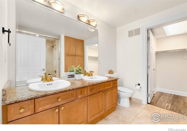 1827 N Grant St Unit 604, Denver, CO 80203 - bathroom featuring double vanity, a shower, and tile patterned floors