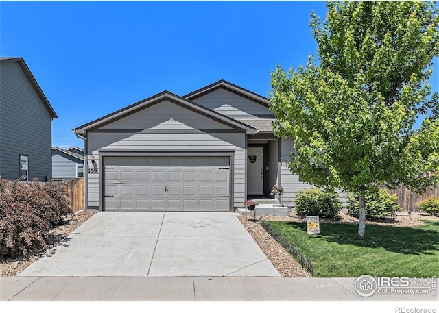 2065 Wildwood St, Lochbuie, CO 80603 - ranch-style home with concrete driveway and an attached garage
