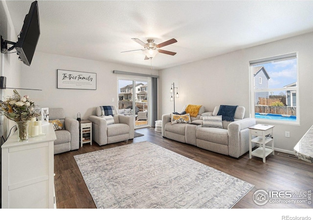 2065 Wildwood St, Lochbuie, CO 80603 - living area with healthy amount of natural light, a ceiling fan, and dark wood-style floors