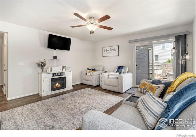2065 Wildwood St, Lochbuie, CO 80603 - living area featuring a ceiling fan, wood finished floors, and a glass covered fireplace