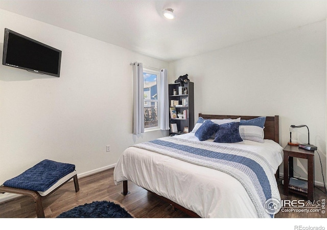 2065 Wildwood St, Lochbuie, CO 80603 - bedroom featuring wood finished floors and baseboards