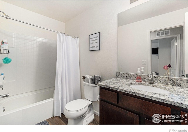 2065 Wildwood St, Lochbuie, CO 80603 - bathroom featuring vanity, shower / bath combo, and wood finished floors