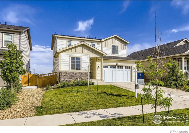 6645 Dry Fork Dr, Frederick, CO 80516 - view of front of property with board and batten siding, a garage, concrete driveway, and stone siding