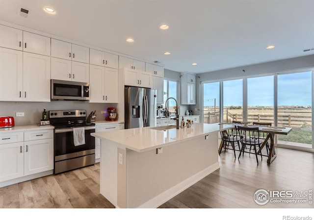 6645 Dry Fork Dr, Frederick, CO 80516 - kitchen featuring appliances with stainless steel finishes, light wood finished floors, plenty of natural light, and recessed lighting