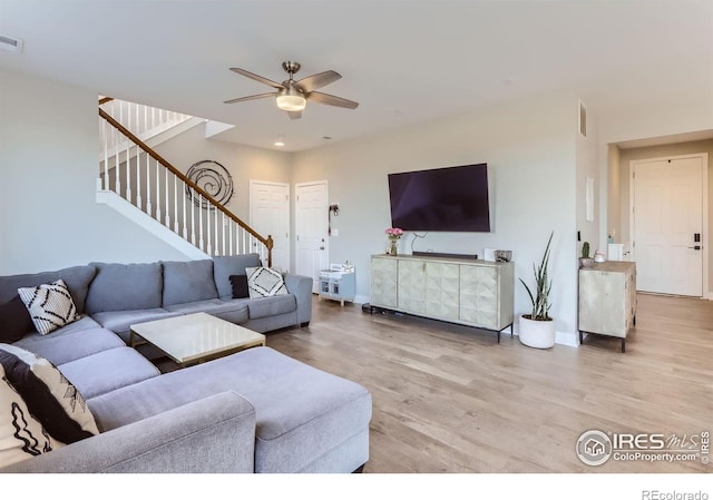 6645 Dry Fork Dr, Frederick, CO 80516 - living room featuring light wood-type flooring, a ceiling fan, and stairway
